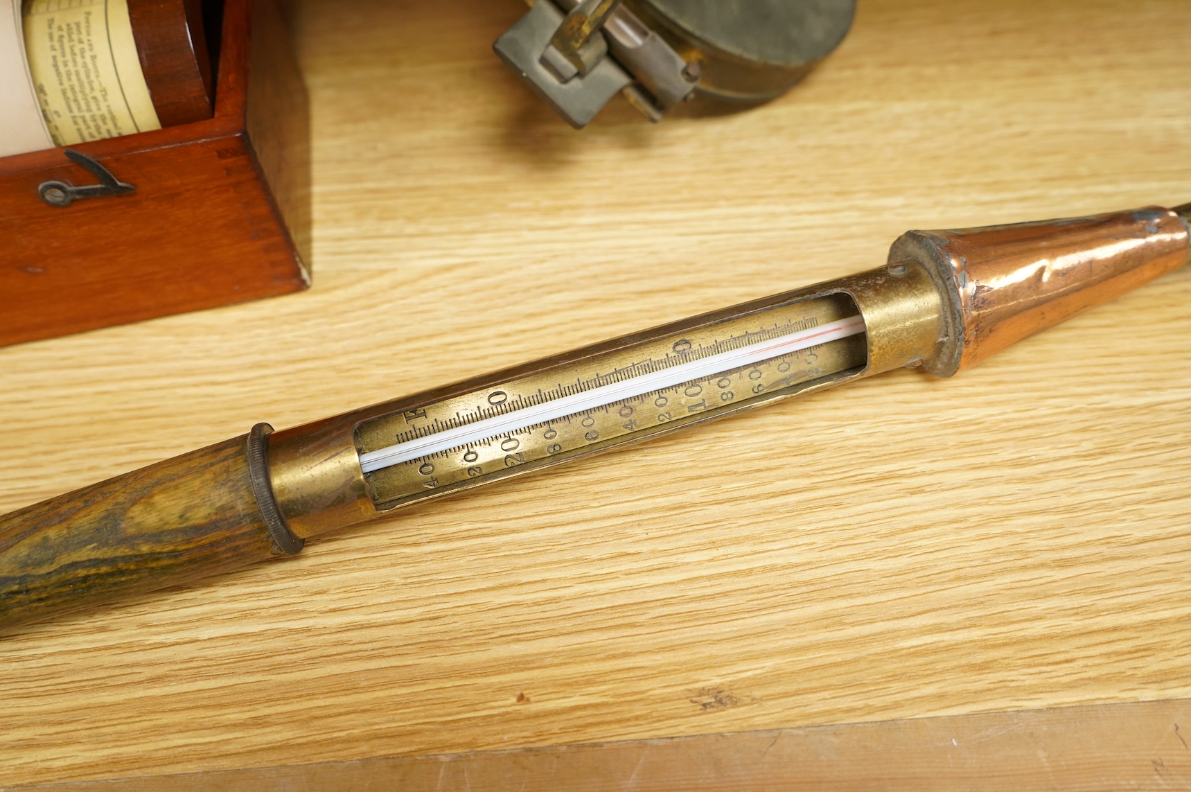 A brass and glass thermometer, with an ash handle, together with an early 19th century brass mining theodolite, by William Wilton, St. Day, Cornwall, (2)